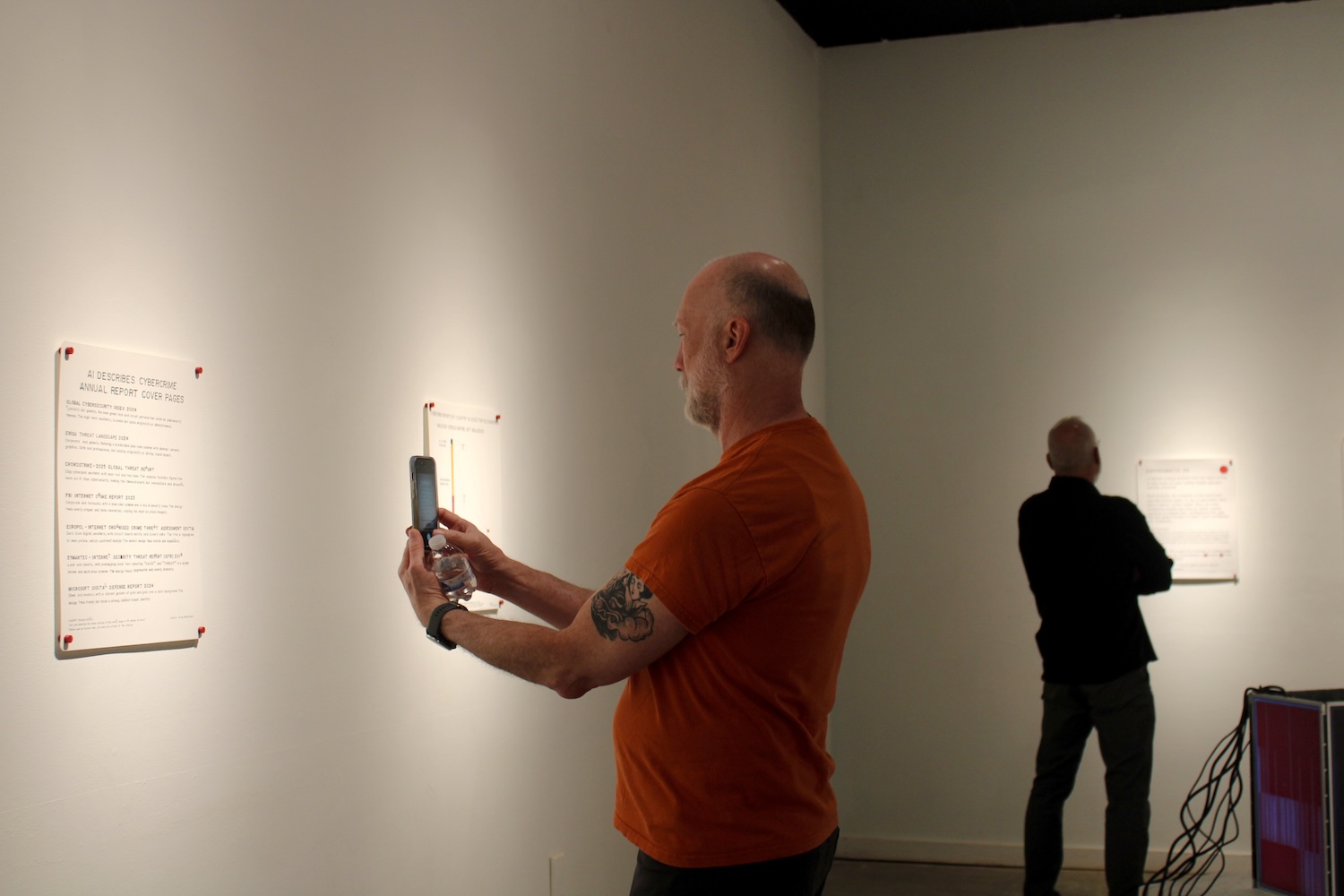 Sparklines Exhibition by Doug MacDowell, man takes picture